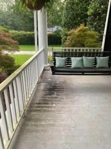 Grimy porch covered in dirt, mold, and mildew before professional pressure washing in Douglas, GA